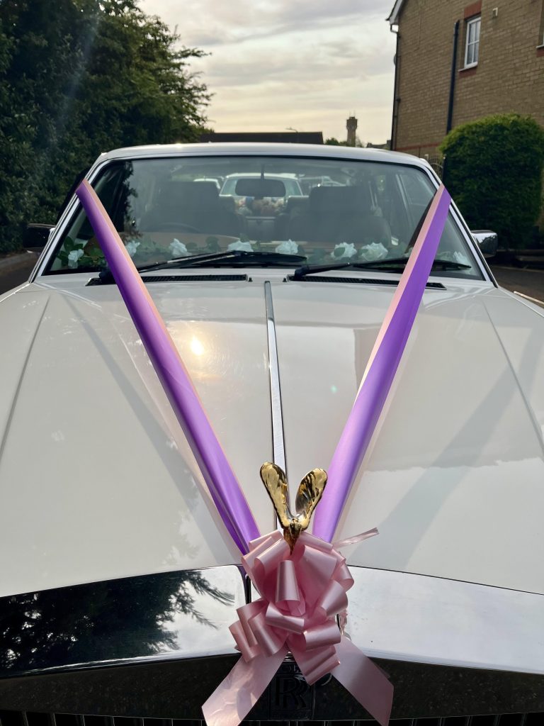 Rolls-Royce wedding car decorated with ribbons in Kent